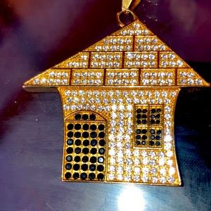 14k gold chain with VS diamonds on a trap house pendant.